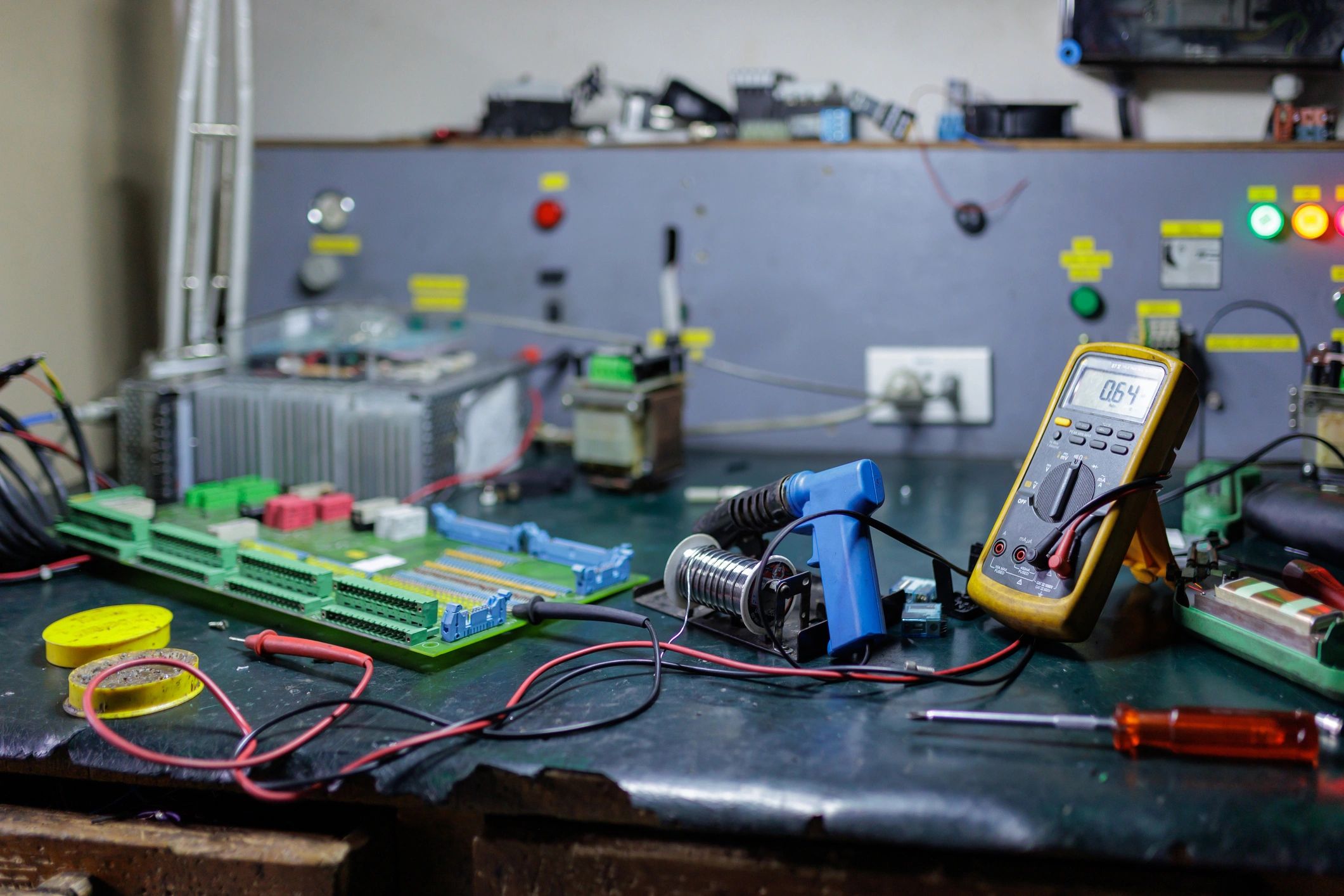 Electronics lab workbench with test equipment and circuit boards