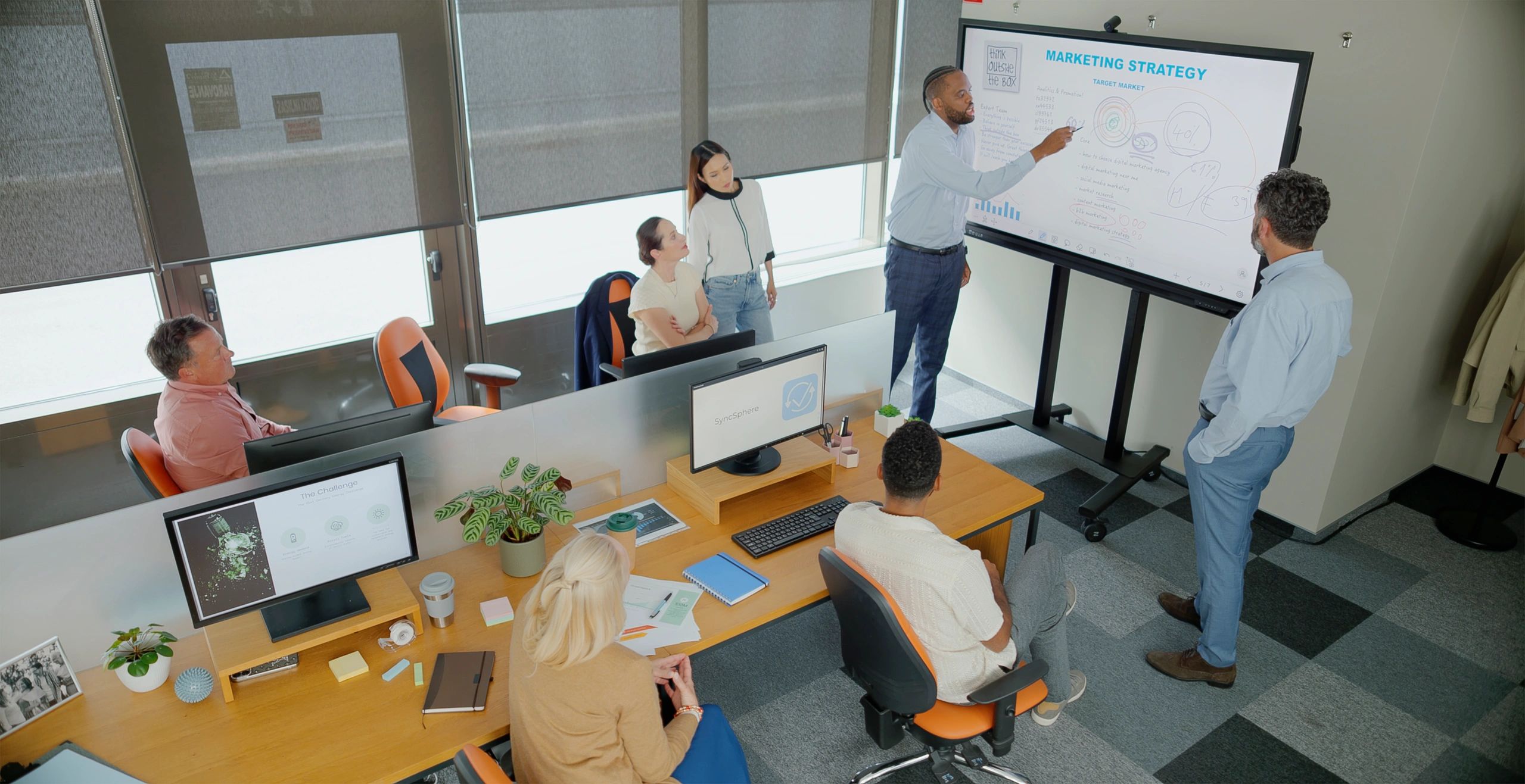 Business leaders collaborating during a strategy presentation